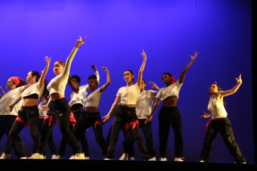 The company performs their winter assembly dance with fierce energy.