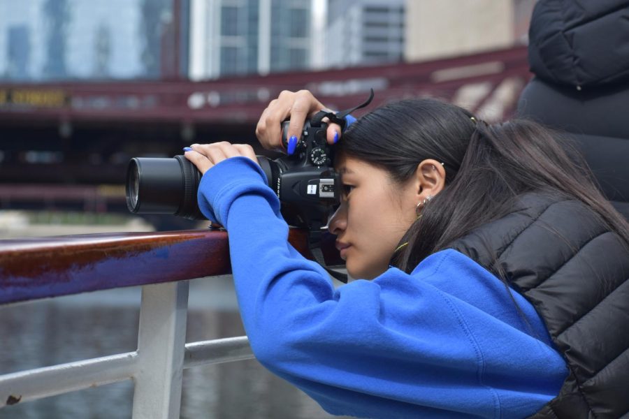 Junior Grace Zientarski balances her camera on the railing in order to make sure she takes no shaky pictures. 