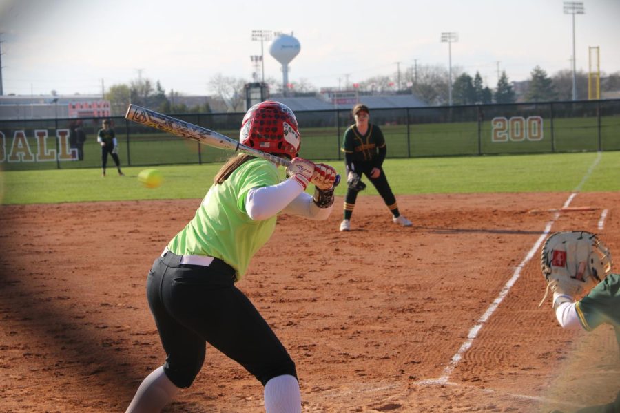 Maggie Burns, senior, about to hit the ball.