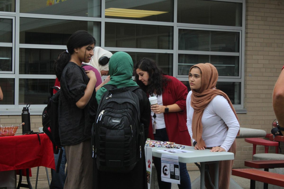 Z Ansari, senior, talks to students about joining the Muslim Student Association.