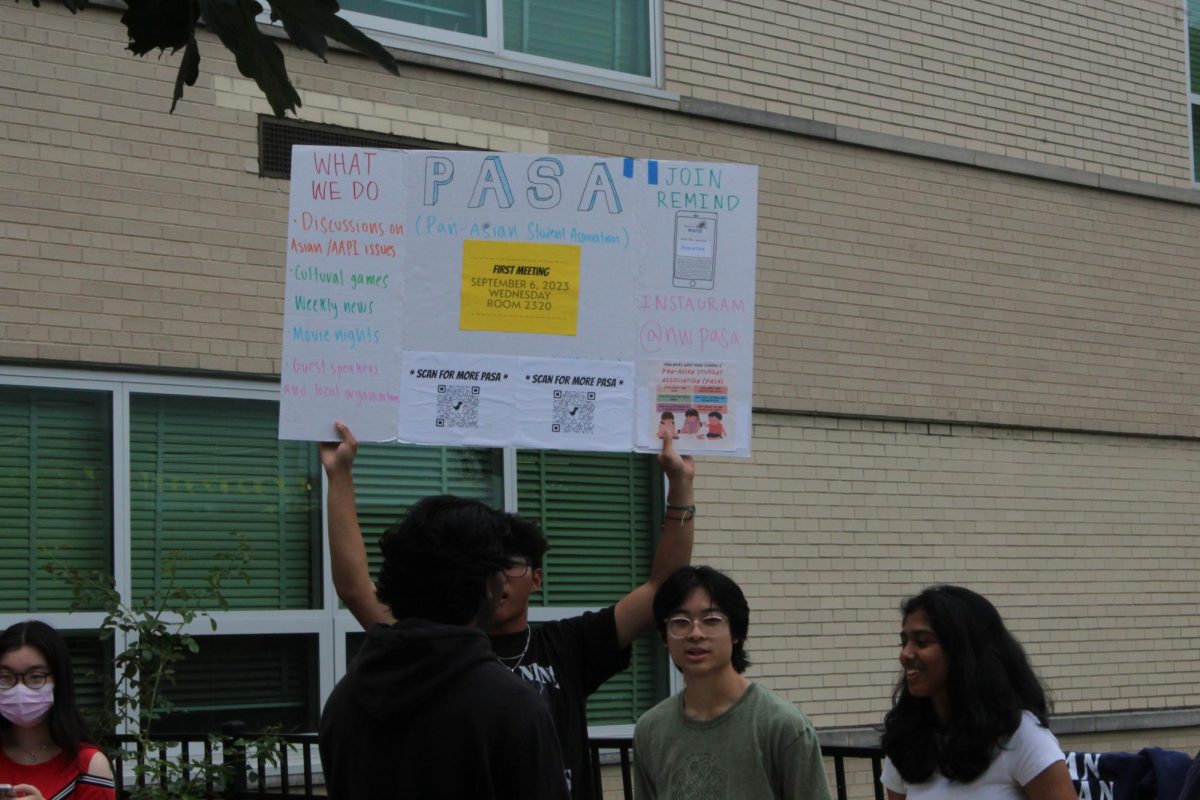 Pan Asian Student Association promotes their club by holding a sign up for the whole courtyard to see.