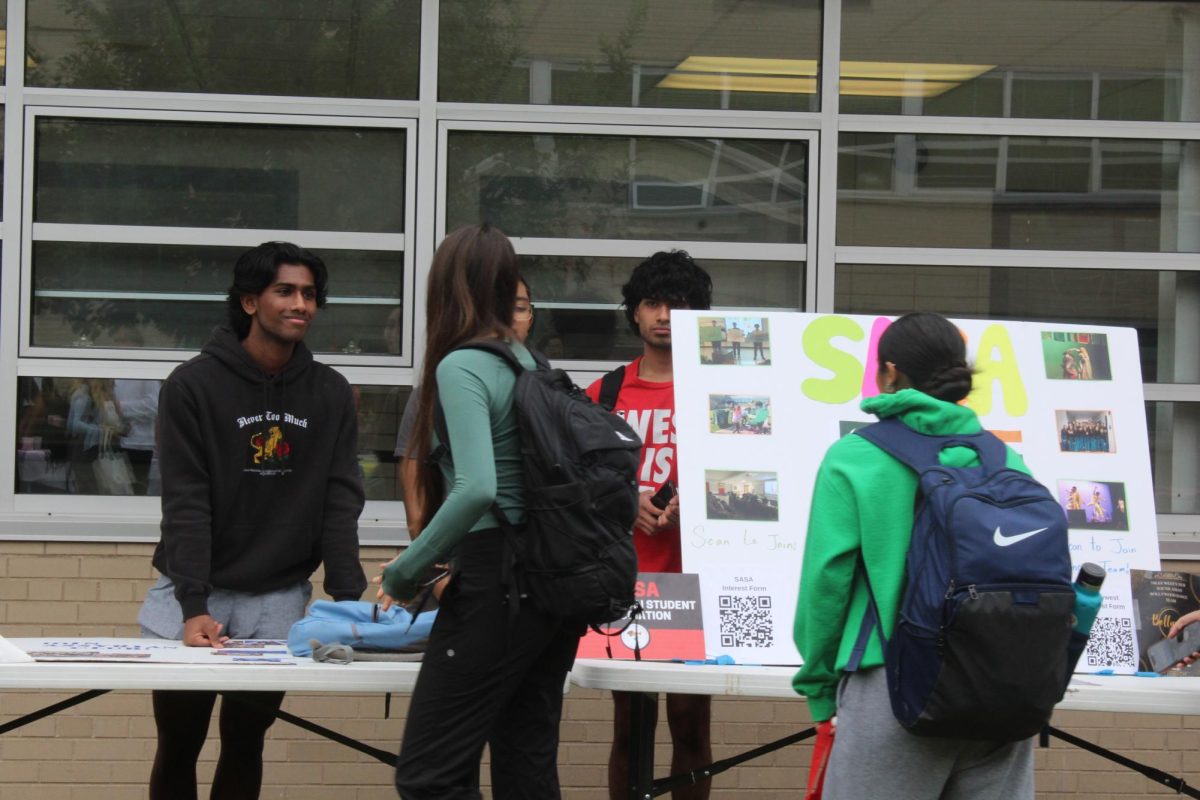 Adraham Chirayil talk to students about joining the South Asian Student Association club.