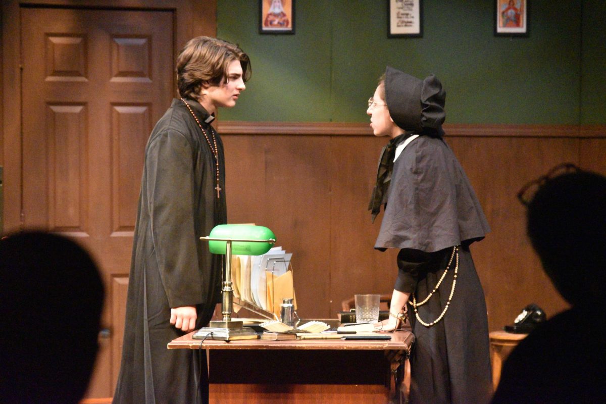 Henry Riley, sophomore, as Father Flynn and Amelia Gottschalk, junior, as Sister Aloysius arguing in her office regarding the accusation of Flynn having an inappropriate relationship with a student. 