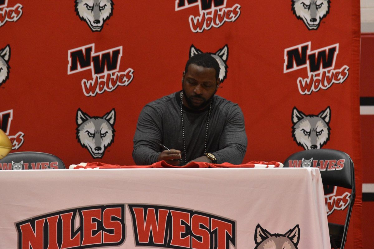 Mendenhall signs his high school jersey, officially retiring the number 5 from Niles West football. 