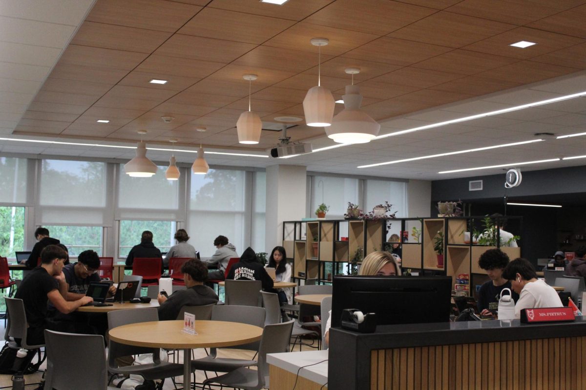 Tables in the back of the library allow students to sit in groups. 