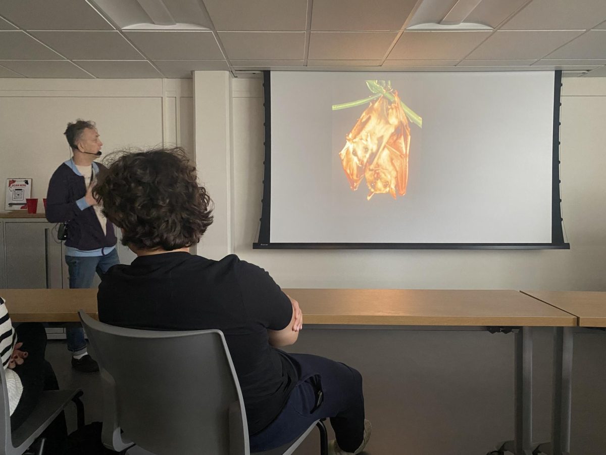 Scott Heinrichs gives a presentation to students about fruit bats. 