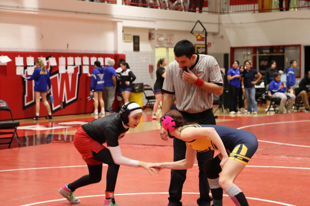 Sarh Al Radi, freshman, ready to try to take down her opponent, as the referee blows his whistle. 