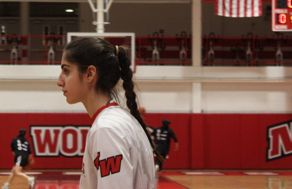 Mary Sarkis, junior, waits during warm ups to get the ball passed to her by a teammate