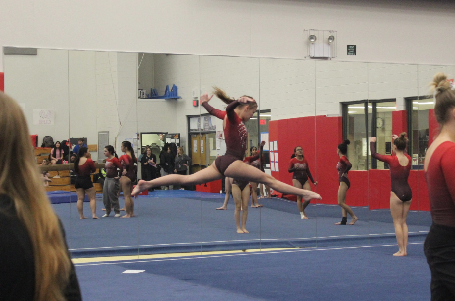 Mariah Malinowski, sophomore, practices her jumps before the meet begins. 