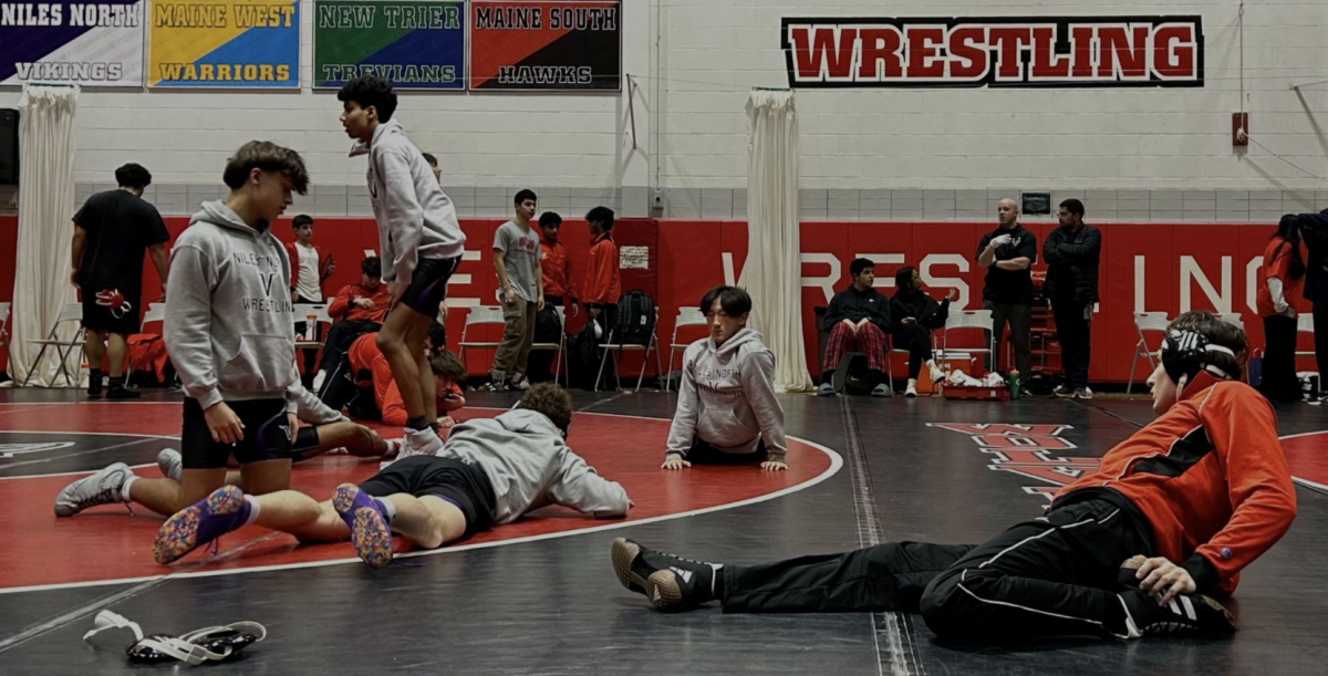 Wrestlers take time before the match to stretch and prepare. 