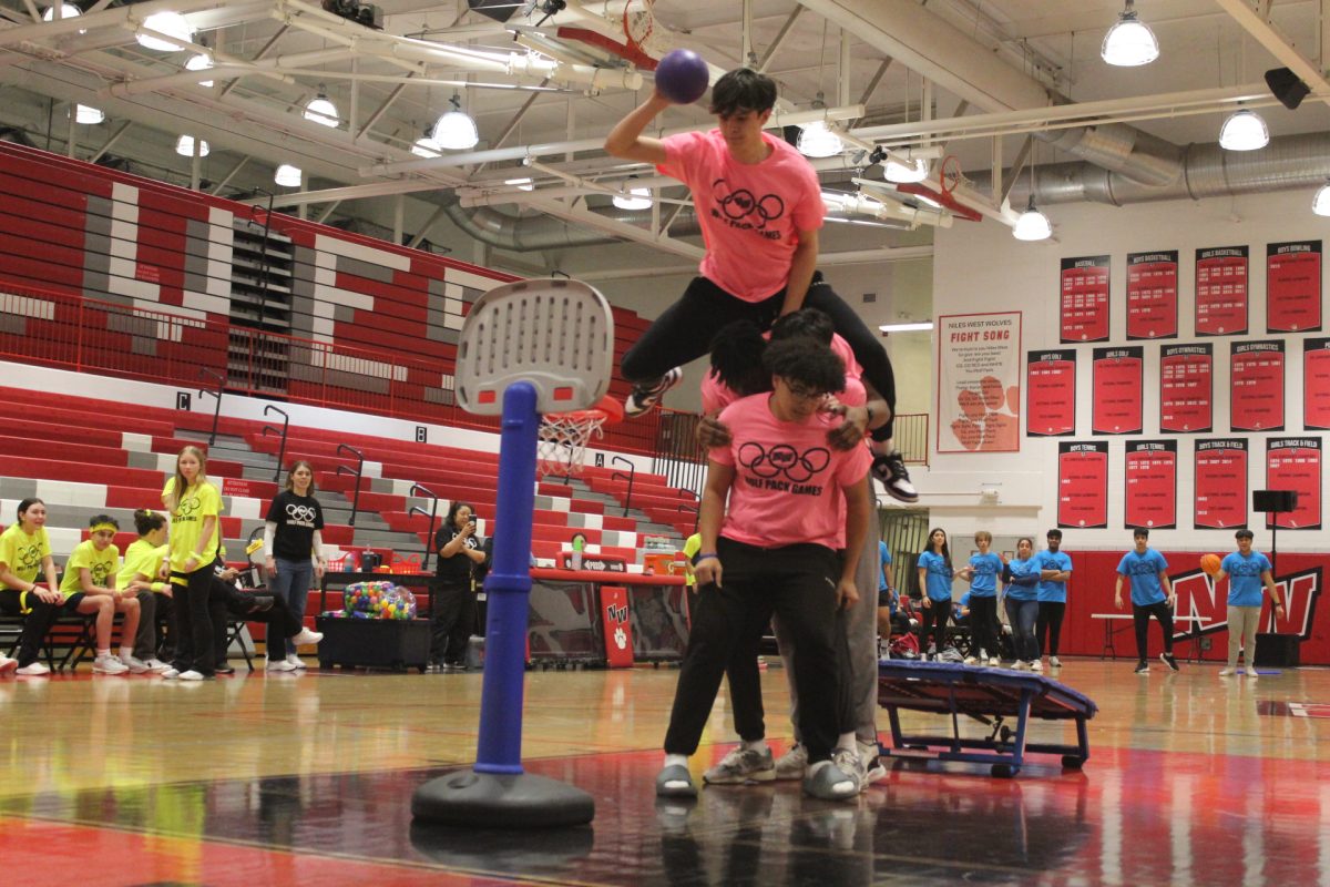 Brandon Pieczka, senior, leaps over his teammates to make a slam dunk in the Slam Dunk Competition. 