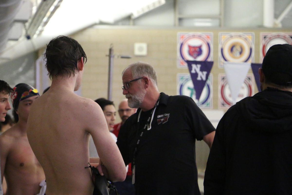 Vanderjeugdt talks to his athletes after their event about what he saw. 