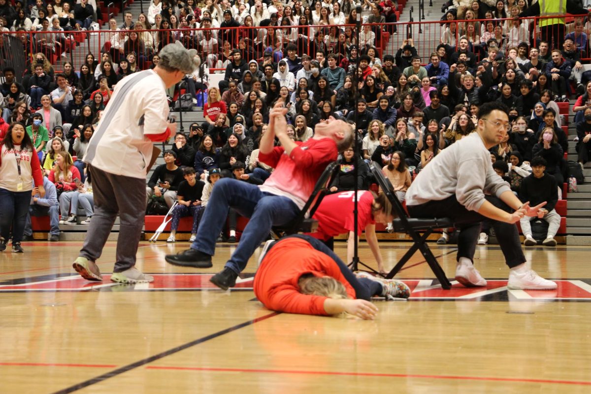 Niles West staff play musical chairs and things take a dramatic turn as more chairs are removed. 