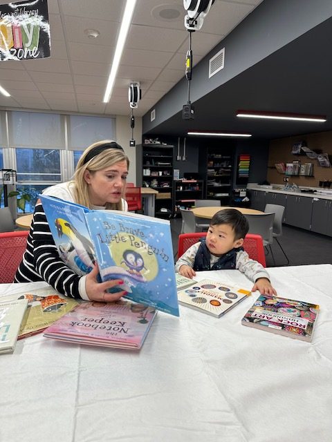 Victoria Pietrus connects to a child by reading to him. 