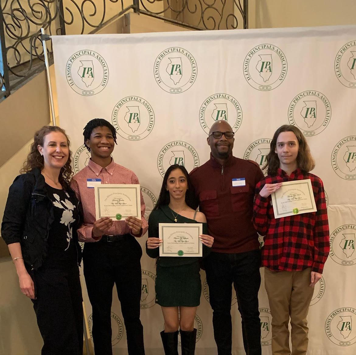 Students and Staff at the breakfast ceremony with certificates (from left to right), Dr. Tucker, Damar Gordon, Tamara Almghrabi, Principal Christian and Timothy Biel.