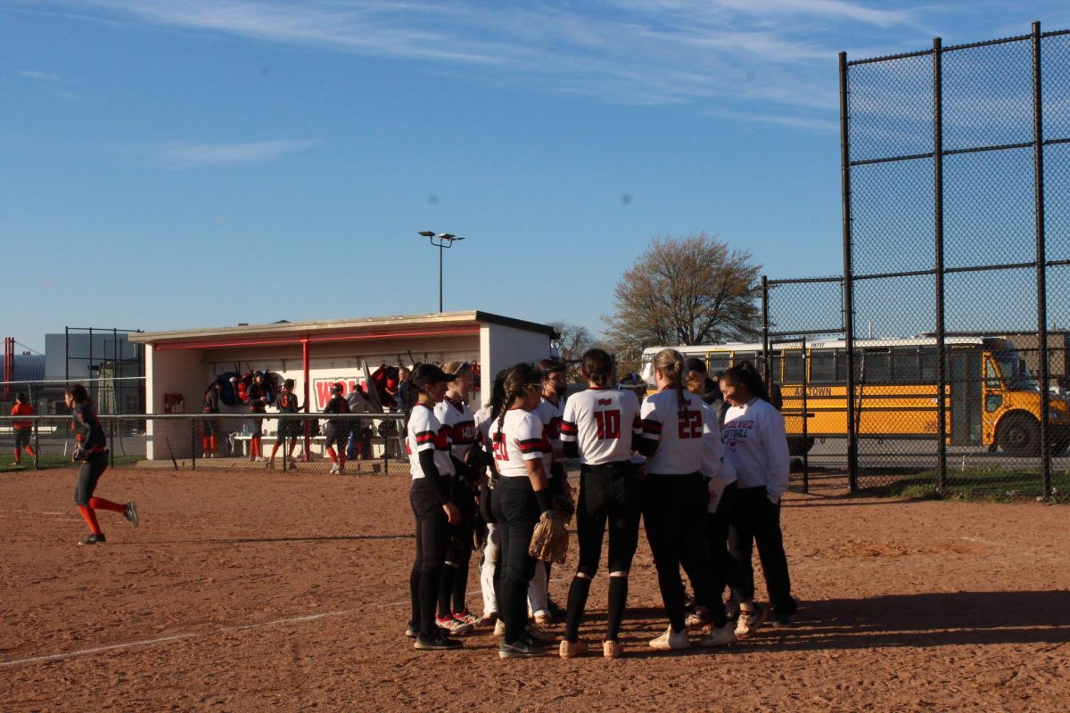 The Wolves huddle around to discuss strategies after being down two runs.