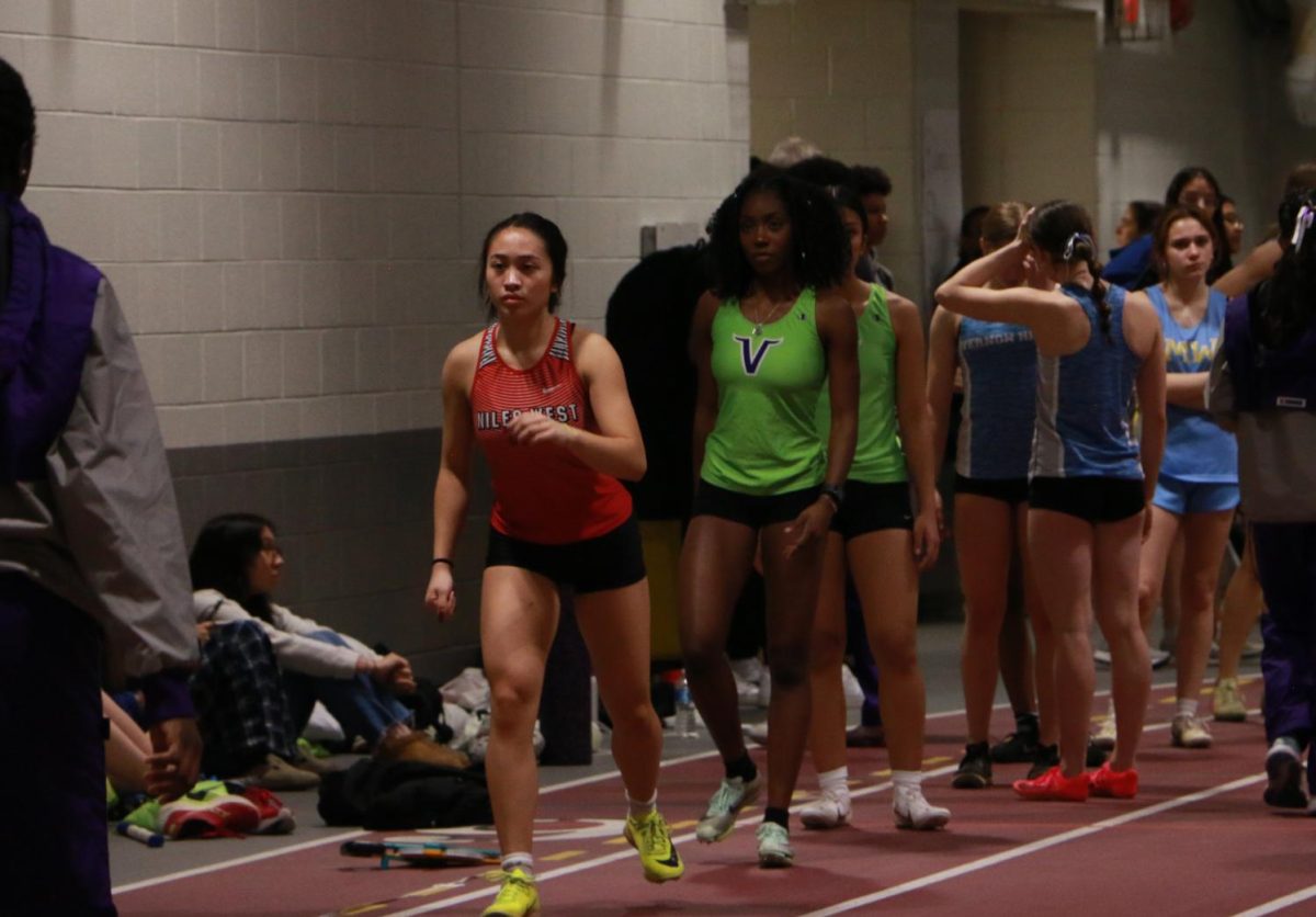 Carissa Uy, junior, gets into position to perform a long distance jump. 