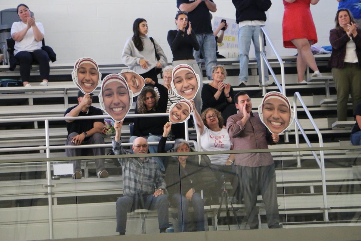 Abby Lopezs family cheers her on with cutouts of her face