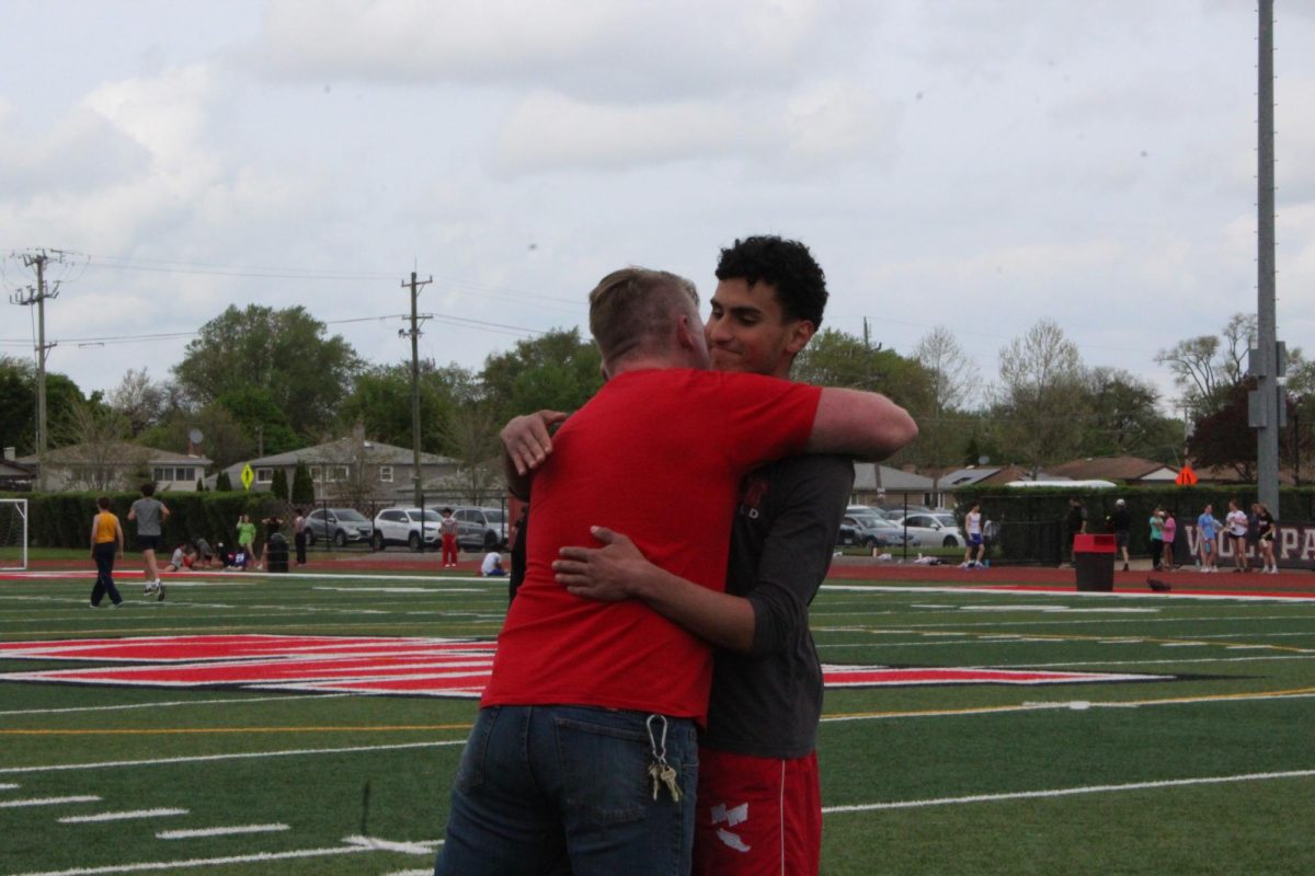 Pole Vault coach Ben Brzenski pulls four year athlete Murad Sawalha in, as it is the last home meet he will compeat at