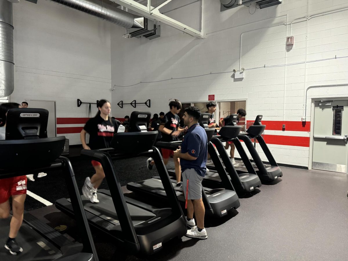 Student teacher aids co-ed Freshman PE students in the Niles West Cardio lab.