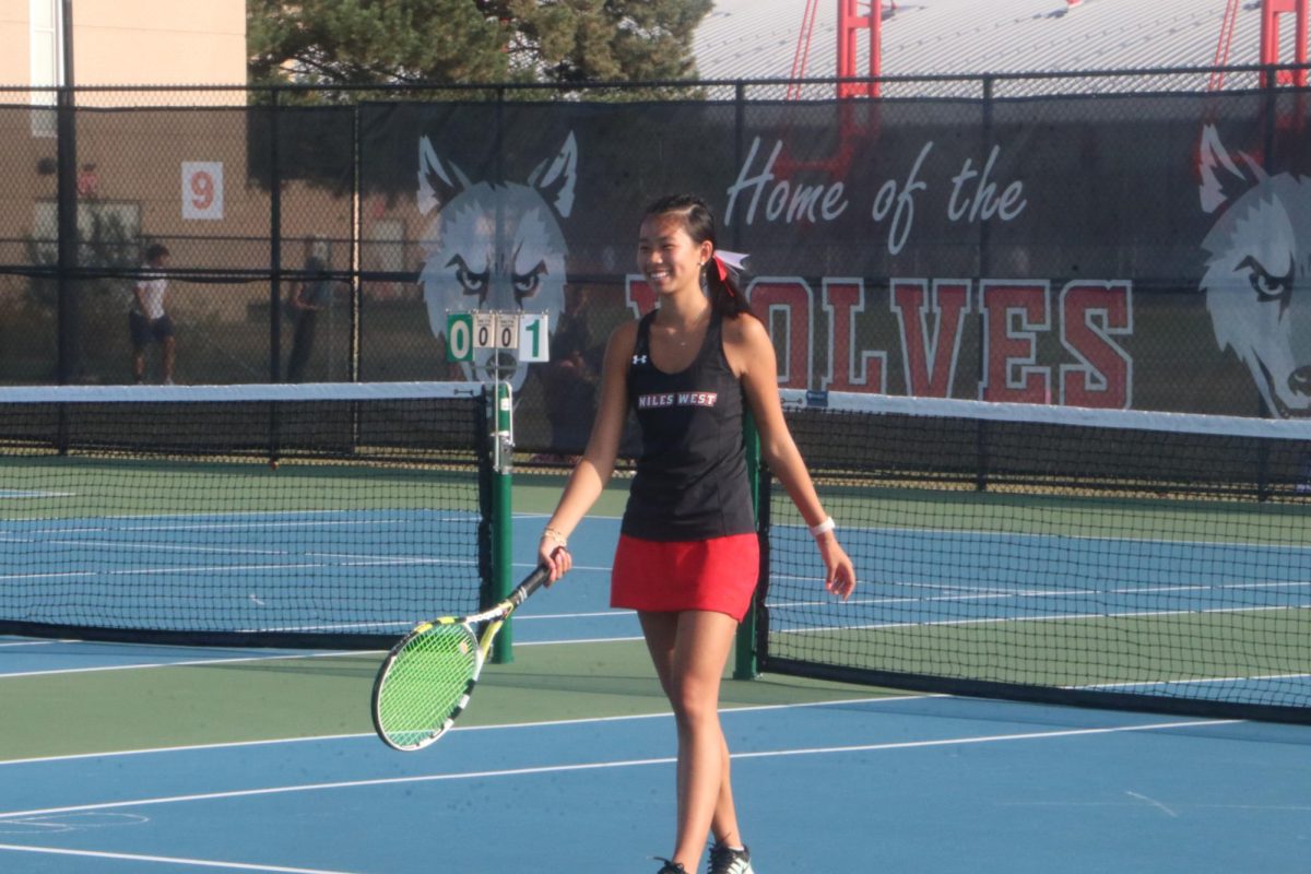 Senior, Tammy Lu smiles as she walks back to serve the ball after earning another point. 