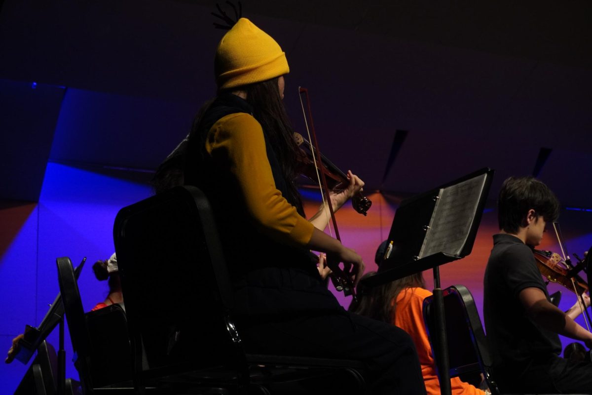 First violinist Anida Mehmedovic, junior, helping lead the orchestra with the help of Director Natalie Frakes.