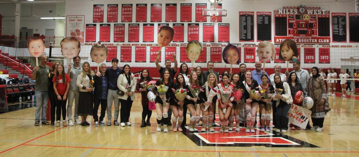 All the seniors line up with their families to take a huge group photo. The dads and siblings have fun throwing up the baby pictures. 