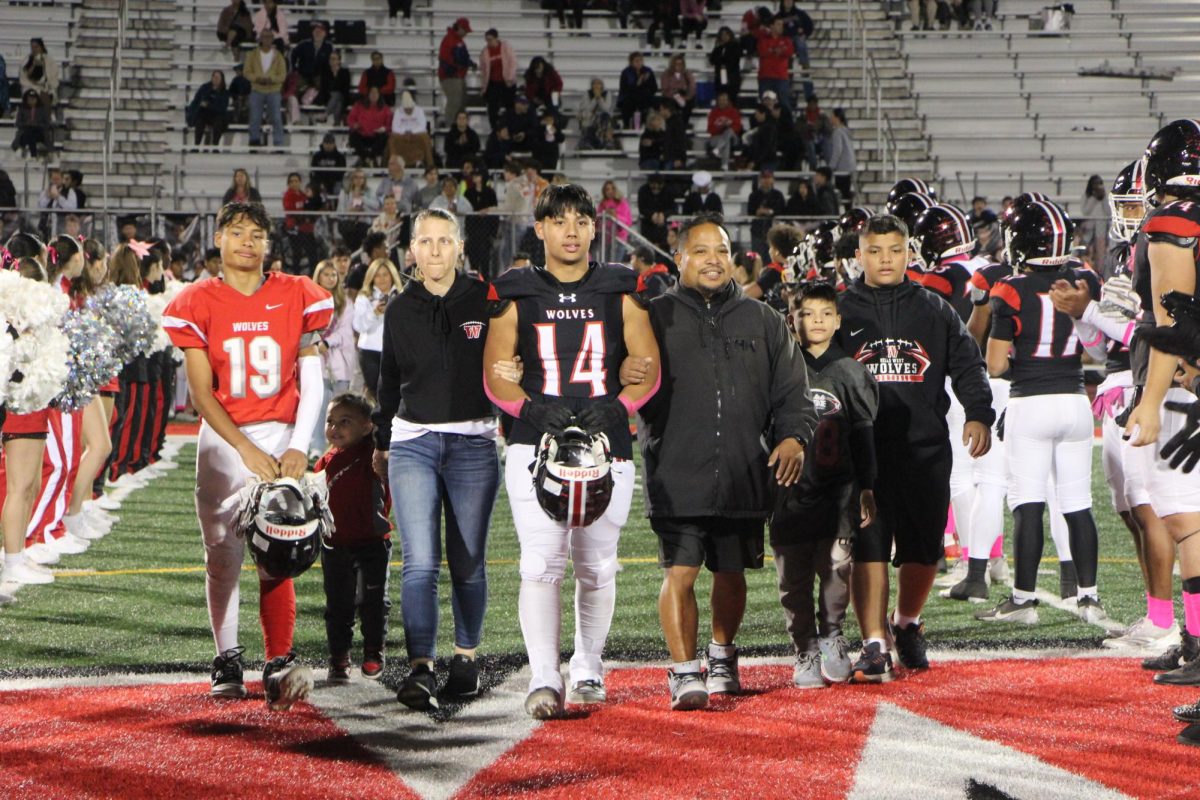 Senior Austin Mulingbayan, varsity football defensive tackle, walks with his parents and younger brothers, including freshman football player Chase Mulingbayan (left).