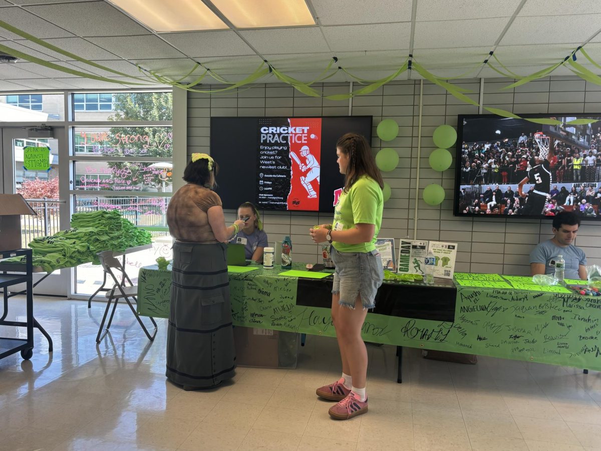 NAMI CCNS setting up to speak to students and hand out lime green wristbands and shirts.