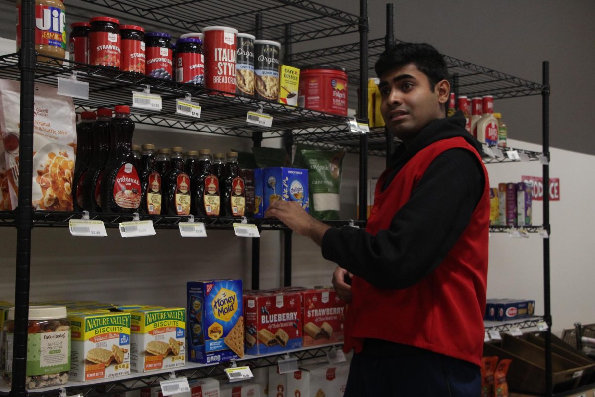 Bridges student Ryan Johnson stocks the shelves of Target mock-up store 