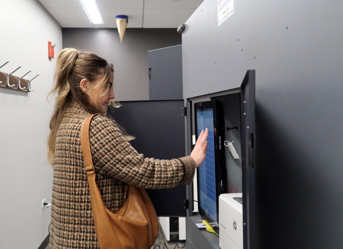 Jackie Chis (West alum '16) gets ready to cast her vote at the Lincolnwood Public Library. She showed up to vote because she believes that the result of this election may have an adverse impact on women across the country. "I think that this election has the potential to be a very historically significant one—we might even have our first female black president. When I'm voting, I'm voting for women like me and women not like me so they can advocate for themselves," Chis said. 