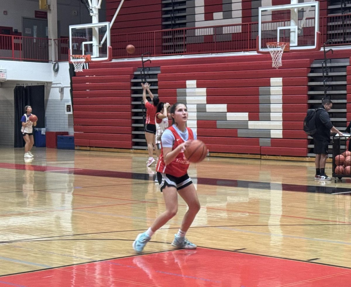 Taking a shot during tryouts, Anna Alpogianis shoots a free throw.