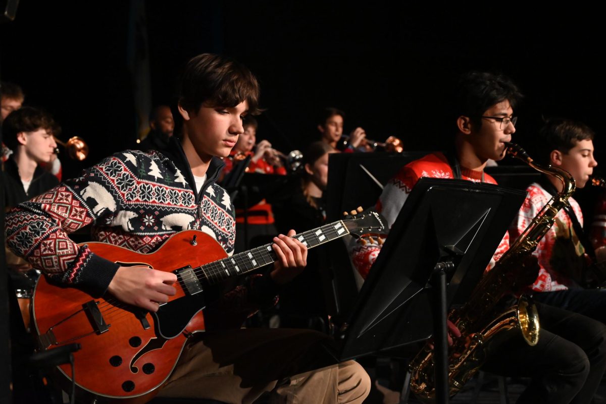 Anthony Burns, junior, accompanies the jazz band on guitar to perform one of their many Christmas songs. 