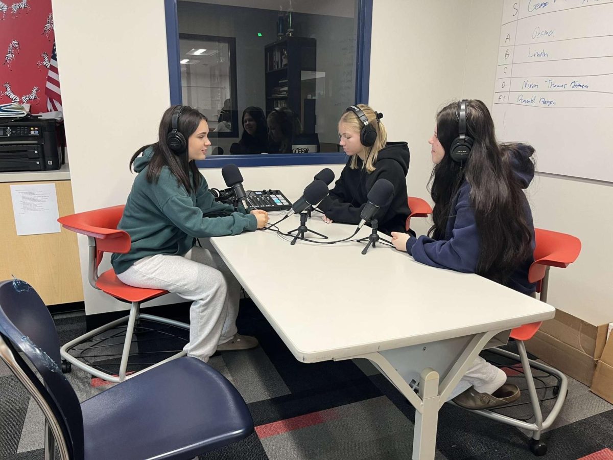 From left, Hanna Schneider, Holly Korzun, and Ava Hortega record a podcast.