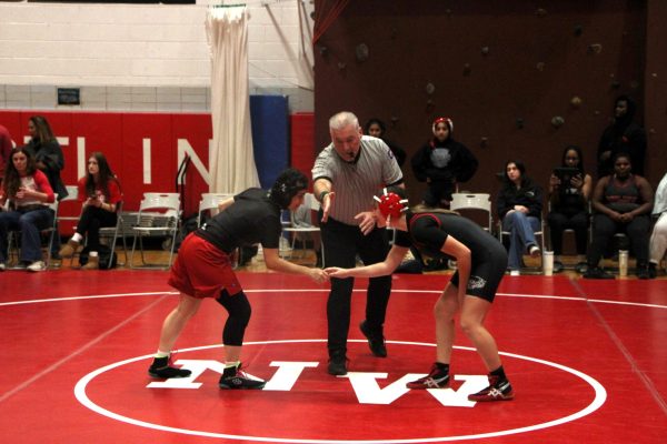 Niles West senior Bella Odisho, left, shakes hands with Phoenix STEM Military Academy opponent. 