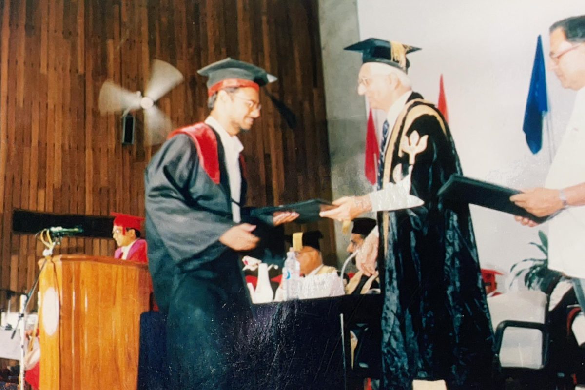 My dad (left) walks onto the stage at his IIT graduation in 1997.