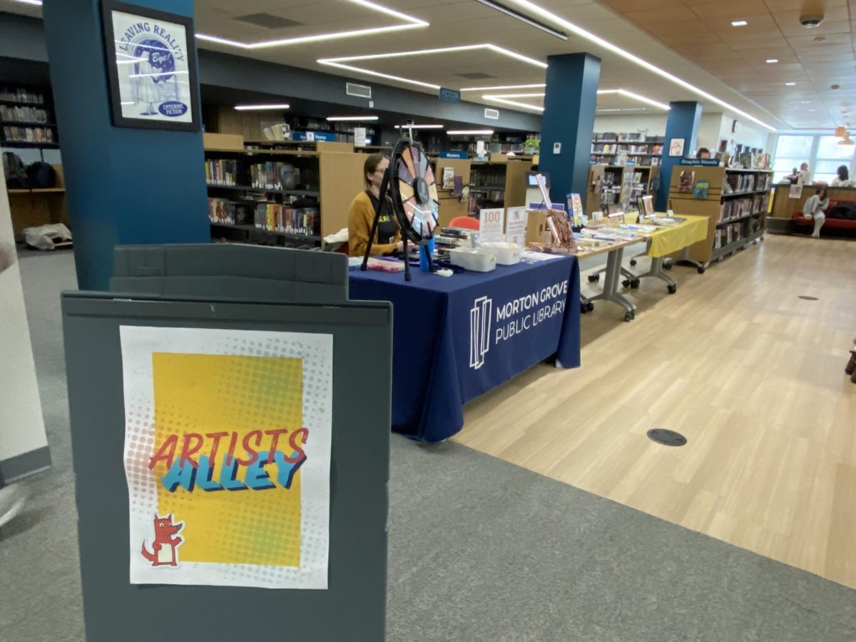 The Artist Alley at Library-con. Tables were set up where you could play games or learn more about the libraries. In the artist Alley they displayed student and local artists artwork. Stickers and bookmarks were sold. They had stations where you play games and learn more about the library.