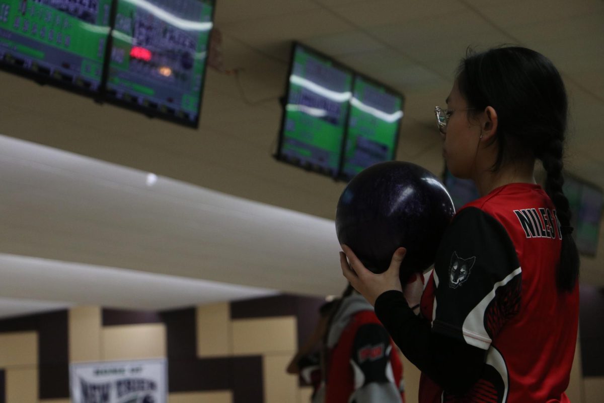 Junior Nichole De La Pena raises her ball to her chin, gearing up to bowl first for her team. The match starts off fast, as New Trier gains on West.