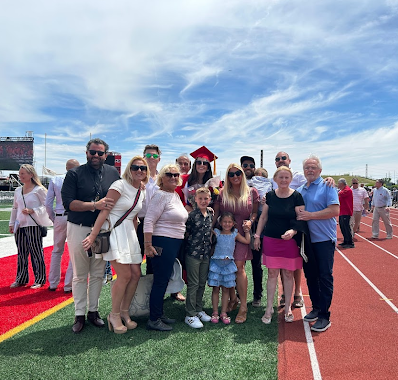 The Cejovic family, and members of the Kljajic family, pose for a photo at Niles West graduation.

In 2023, Mia Cejovic graduated from Niles West, continuing the family's commitment to educational excellence and determination.