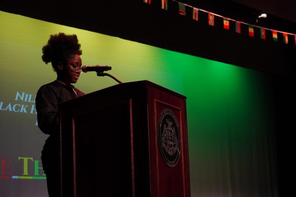 Junior Lydie Boussoukou welcomes everyone to the Black History Month Assembly. This year's theme for the assembly was "More Thank A Skin Tone." "I hope people learned our main goal, which was to overlook the color of our skin when speaking to one another and realize that we are more than the first thing people look at-our skin," Boussoukou said.