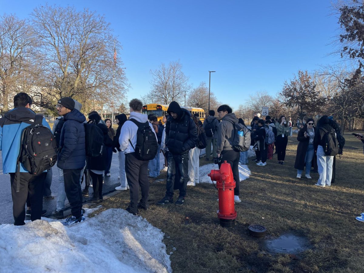 Students talk outside the school after evacuating due to the fire alarm. "I get to school early so that I can prepare for first period, so I'm just thinking about how I still have things to do before first period starts and I want to get back in the building," social studies teacher Megan Spletzer said.