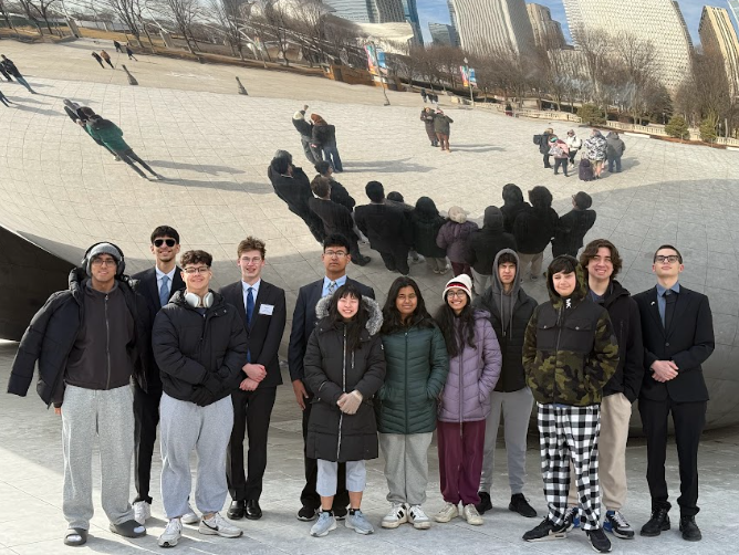 Model UN students posing In front of the bean in downtown Chicago