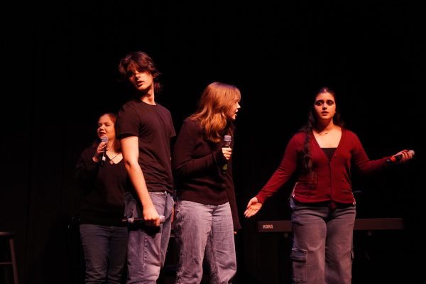 Juniors Jamie Hoffman, Henry Riley, Emma Shimon and senior Abbey DuBois argue over who is to serve as the master of ceremonies for the show. 