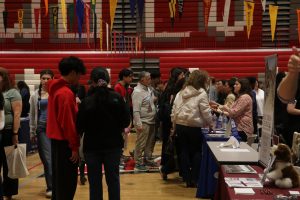 Students and their parents explore a variety of different colleges in the main gym. "I explored a lot of colleges I didn't know about...I found a Texas one I didn't know about...I loved it. I'm definitely going to research more about it and check the website. They had a lot of scholarships and lots of majors. I thought that was really cool," Niles West junior Bethanie Sorisho said. 