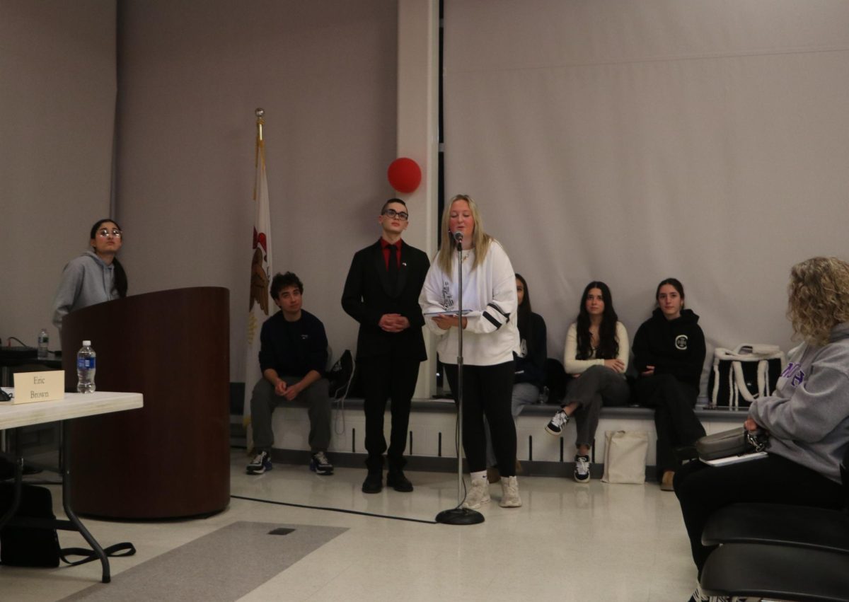 Seniors August Bicknese-Klein and Emma Aufegger go through the rules of the forum and give an overview of the night. 