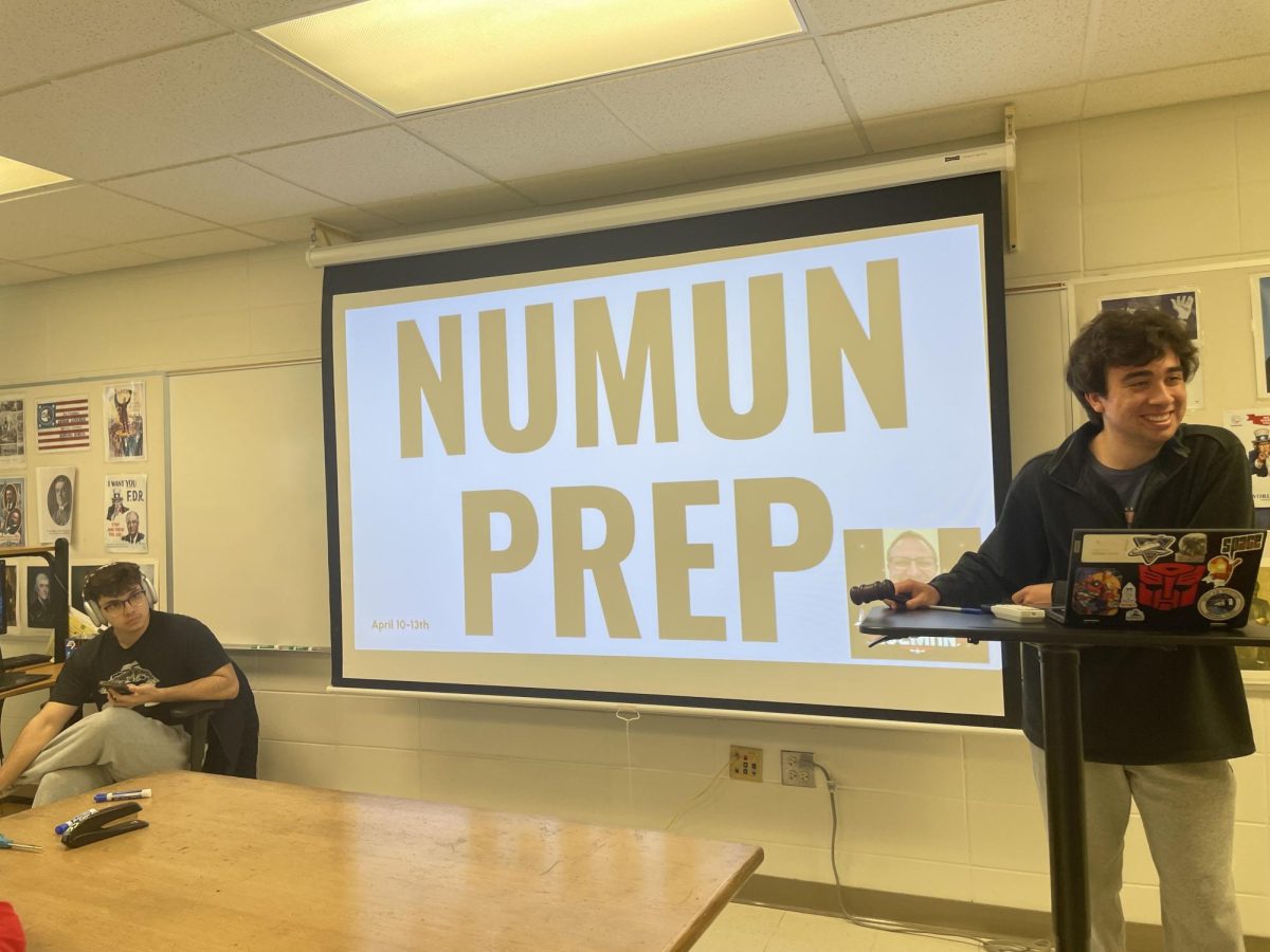 Senior Lucas Rosales (right) leading Model UN as they prepare for a conference. 