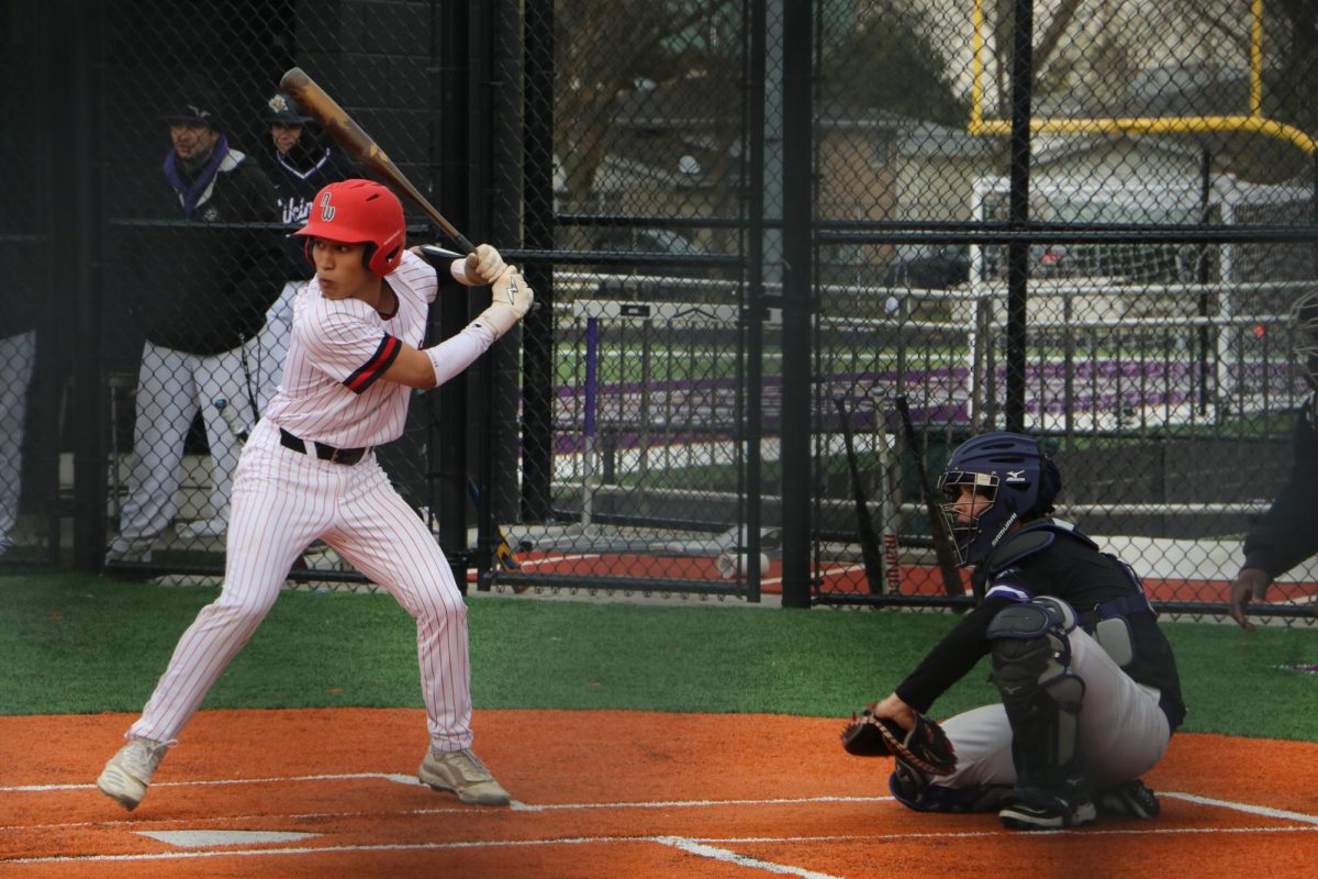 Leading off for the Wolves, junior Lucas Som tracks the ball as it is being pitched. 