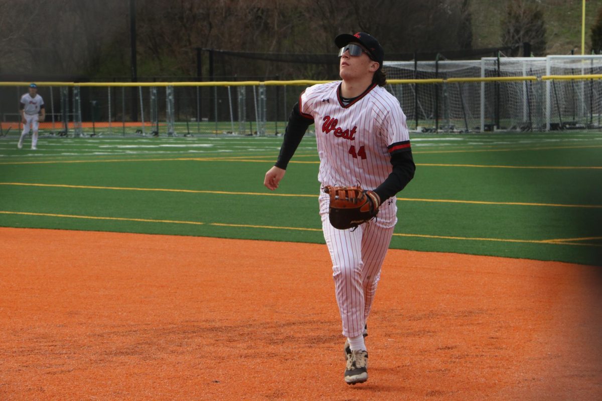 As a Viking hits a pop fly, senior Scott Stewart tracks the ball down by first base. 