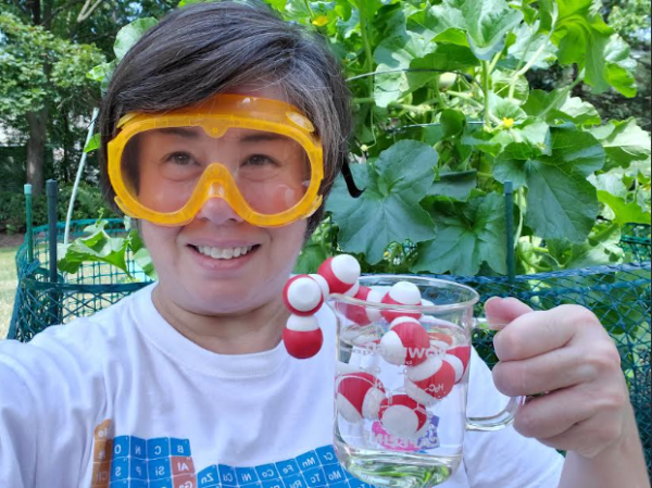 Ami LeFevre poses with glass of atoms
