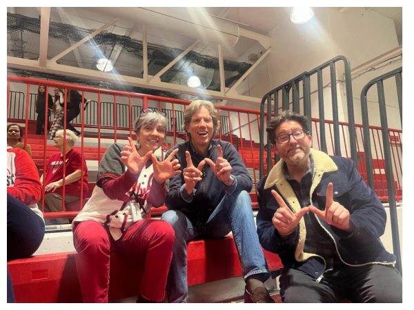 Blake Magnuson (center) attends a West girls basketball game during the 24-25 season with English teacher Michele Hettinger and English department director Michael Kucera.
